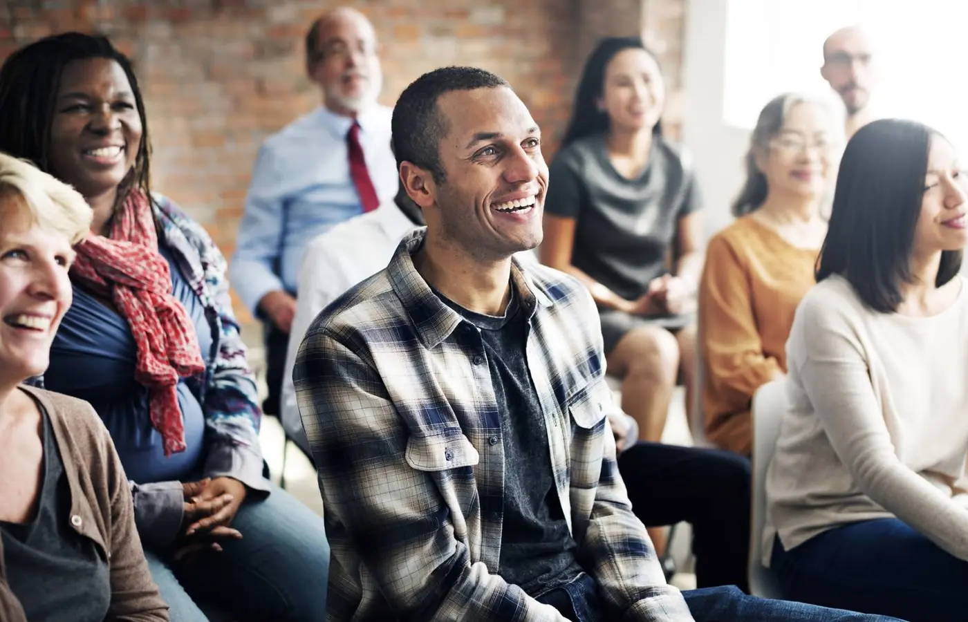A group of training delegates smiling and listening