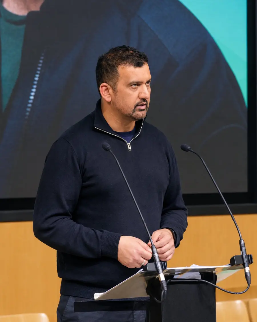 Farhan Hayat speaking at a lectern